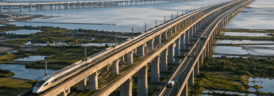 Ultra-long modern bridge stretching across water, wetlands, and infrastructure to represent the longest bridges in the world
