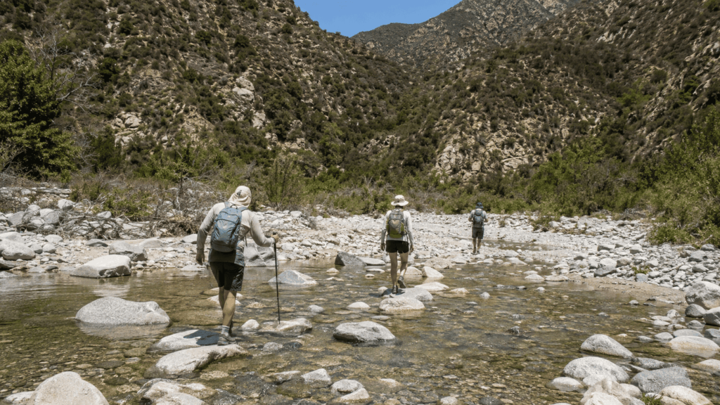 Hikers crossing the East Fork of the San Gabriel River on the Bridge to Nowhere trail